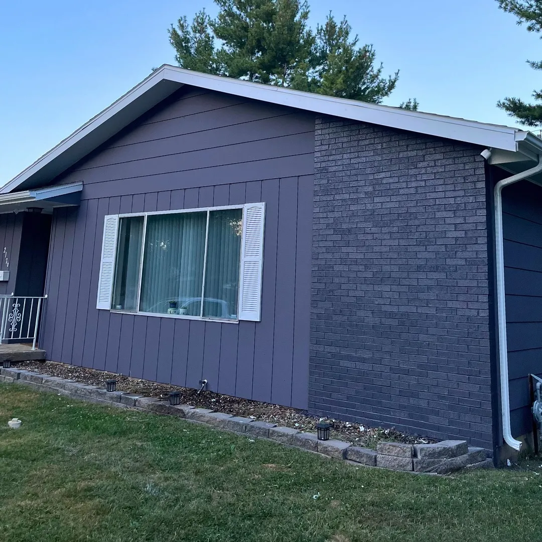Professional exterior house painting with blue siding in Springfield IL